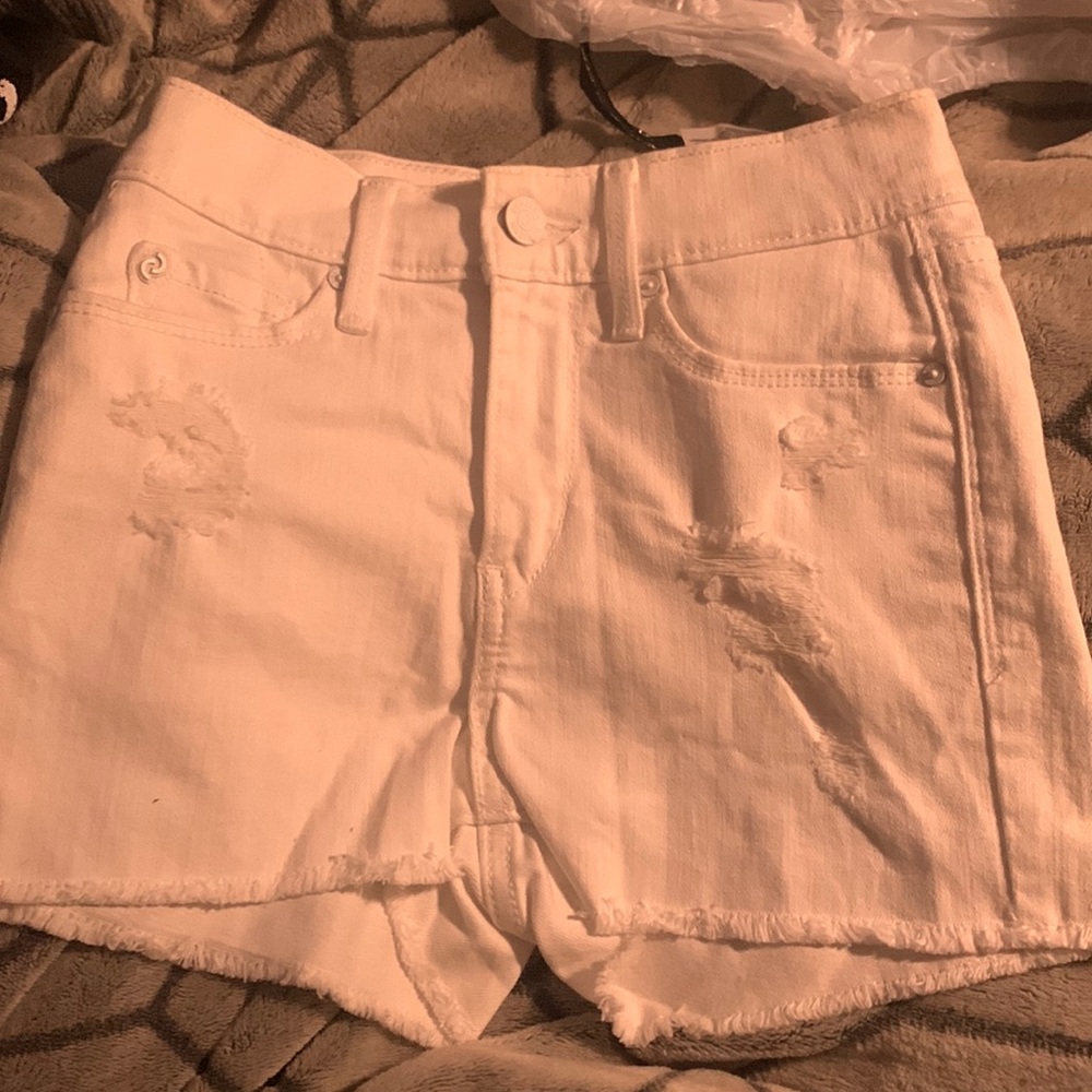 white jean shorts with rips